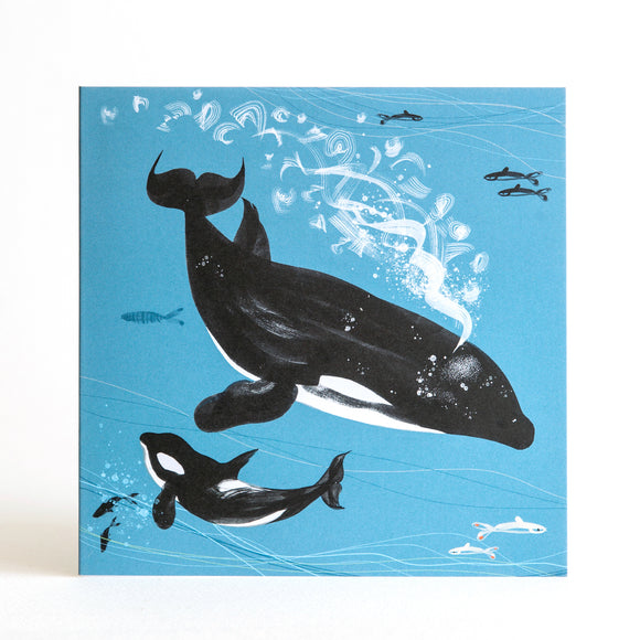 Orca killer whale swimming with her calf in deep blue ocean with fish and bubbles