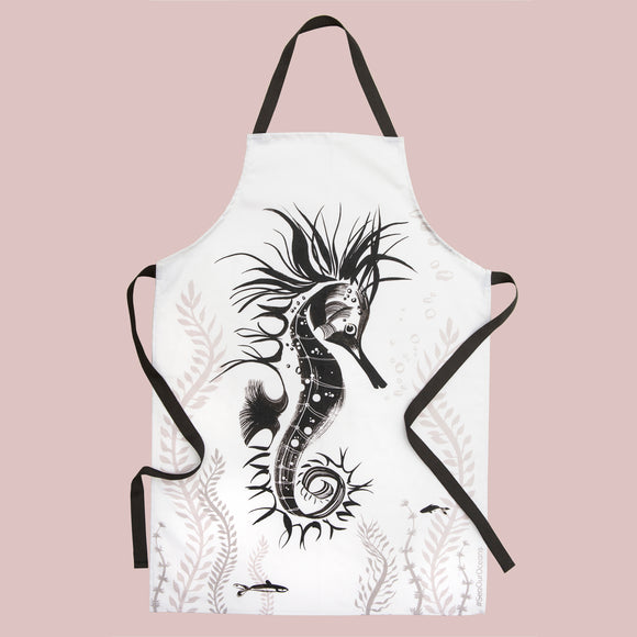 Illustrated Seahorse tea towel on stove and an oven glove hanging on the oven door handle