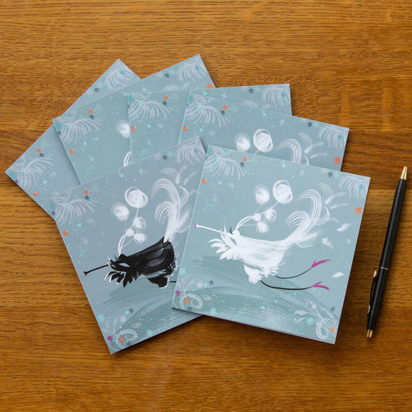 A set of six square cards, same fun design, but 3 with a black flute bird and 3 white flute birds, flying whilst playing their flute-like beaks. Background is a 30's teal colour with mainly white or black brush lines