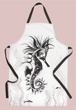 A Seahorse illustrated white cotton apron with black ties infant of a plain brick wall. A large black and grey loose brush drawing of a floating seahorse