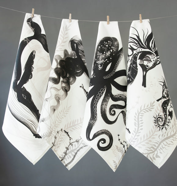 Mixed set of four napkins hanging side by side with a peg of a whale, jellyfish, octopus and seahorse